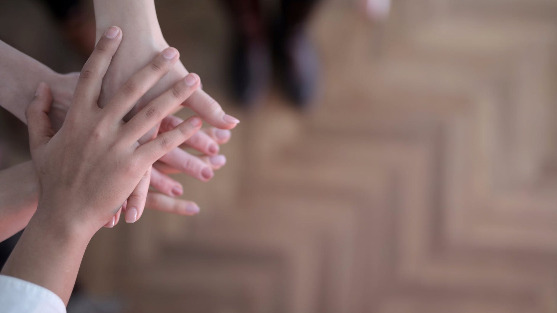 Support network in Narcissistic abuse recovery - Diverse group of individuals holding hands in solidarity.