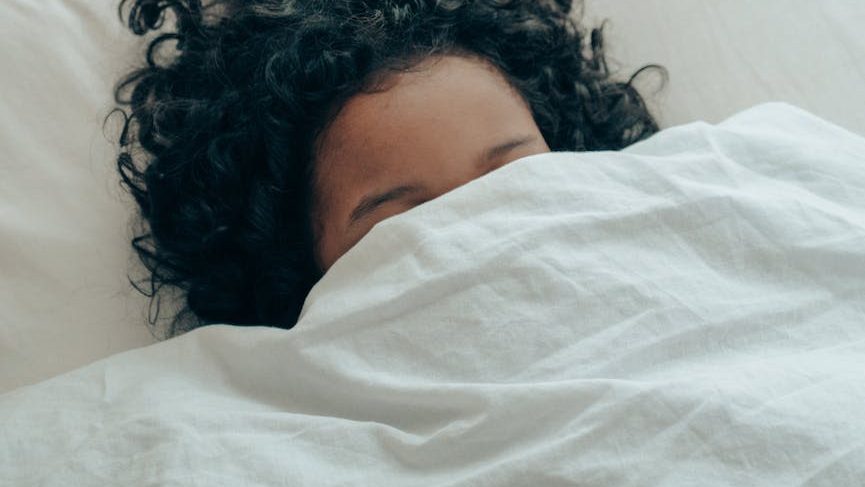 A person meditates with a serene expression on their face, promoting mindfulness and self-awareness. Jennifer Adair LPC, Onesta Therapy Co.