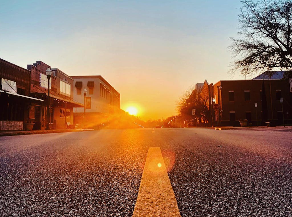Sunset over Downtown Conroe: A stunning sunset casts warm hues over downtown Conroe, providing a serene backdrop for reflection and personal growth.
