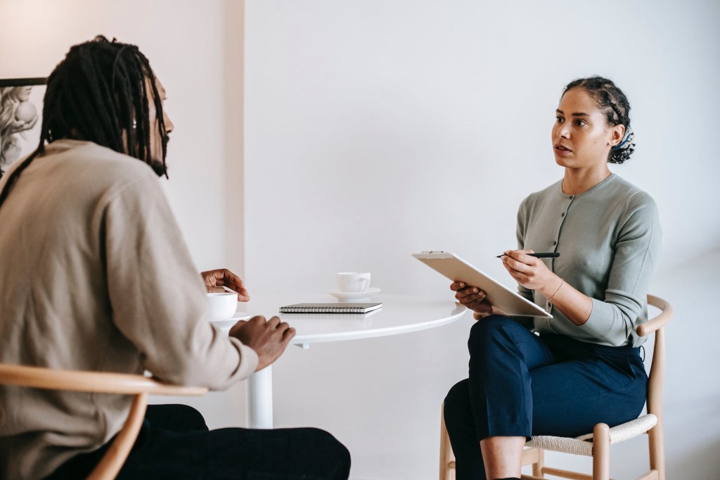 A therapist offers support and guidance to a client navigating change and uncertainty, fostering resilience and personal growth. Jennifer Adair LPC, Onesta Therapy Co.