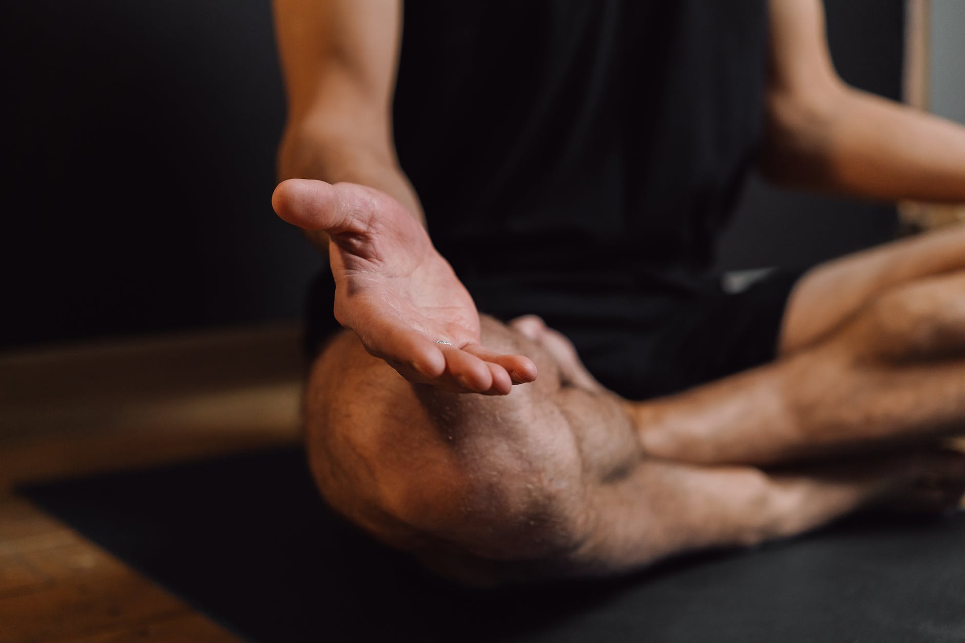 A person practicing mindfulness meditation, sitting cross-legged with eyes closed and hands resting on knees, illustrating the use of mindfulness techniques for managing chronic pain and promoting emotional well-being.