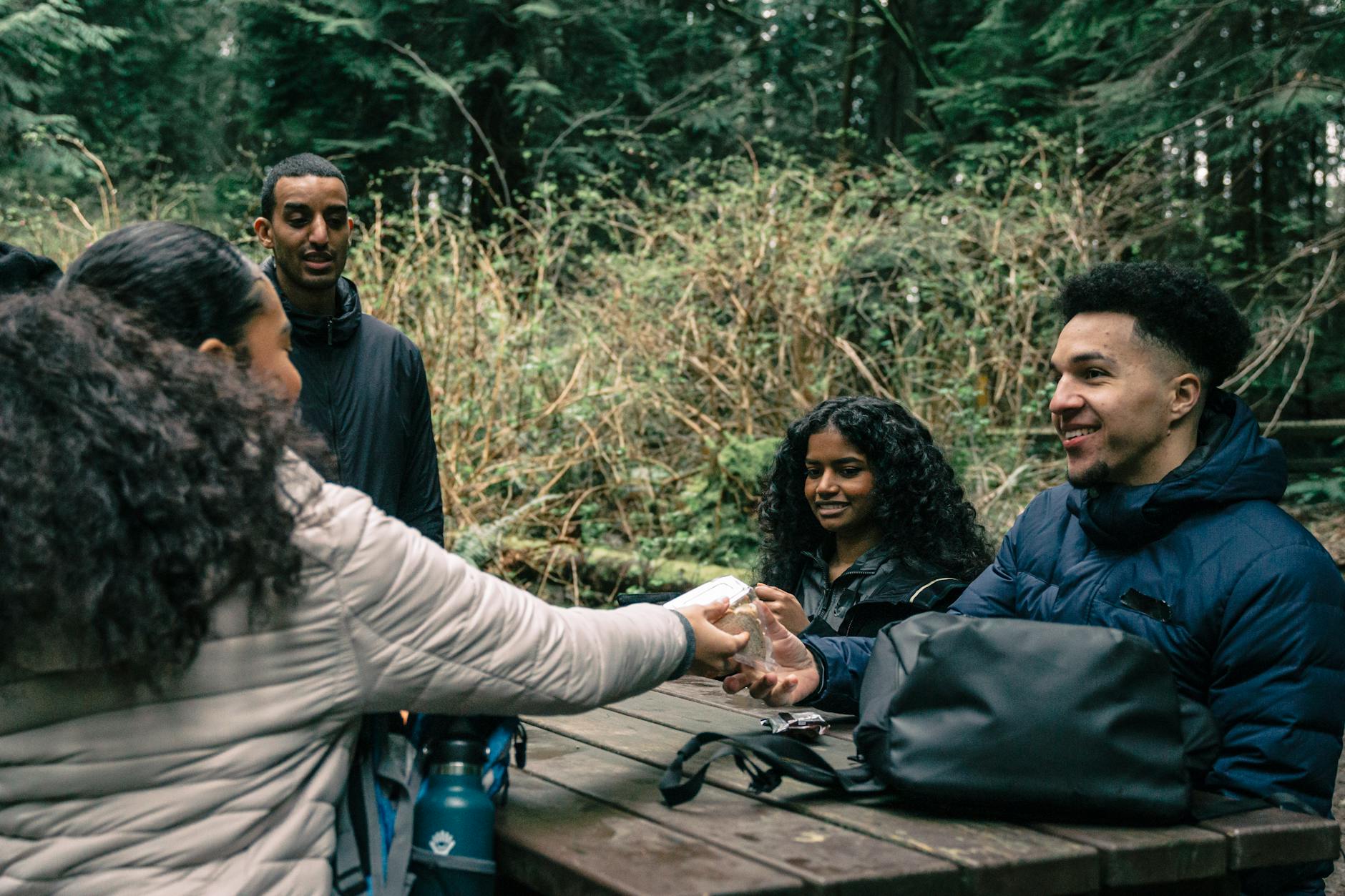 Diverse group of people sitting in circle, engaged in conversation and offering support to one another.