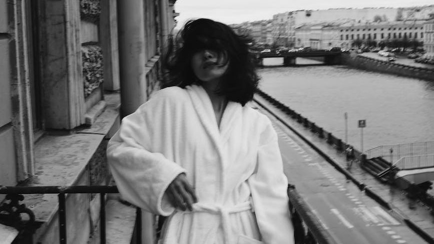 A person stands confidently amidst a backdrop of imperfections, embracing authenticity and self-acceptance. Jennifer Adair LPC, Onesta Therapy Co.